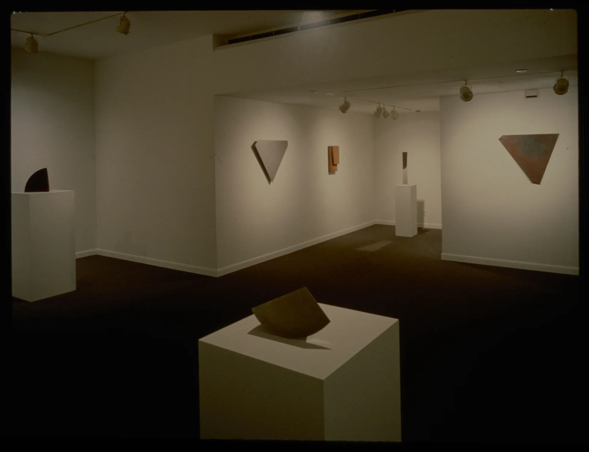 Form studies are both hanging on the walls and displayed on pedestals. Each study has its own unique shape and form.
