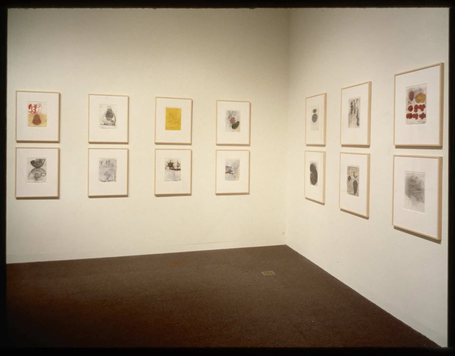 Works hang in two equal rows going around the gallery walls. The works hang in pairs where one is on top of the other.