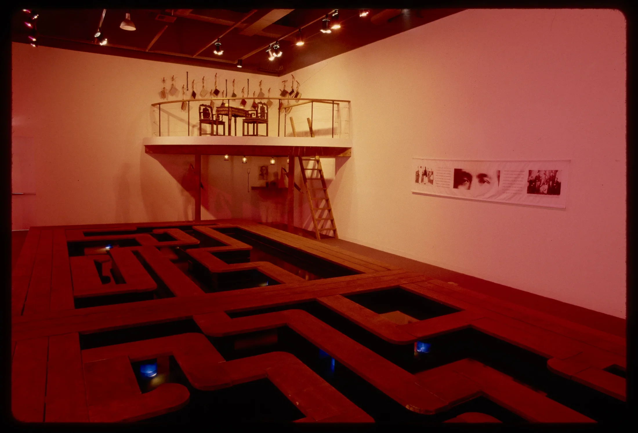 A walkway takes up the gallery while a rafter is set up the wall in the back corner. A ladder is set to climb the rafter. 