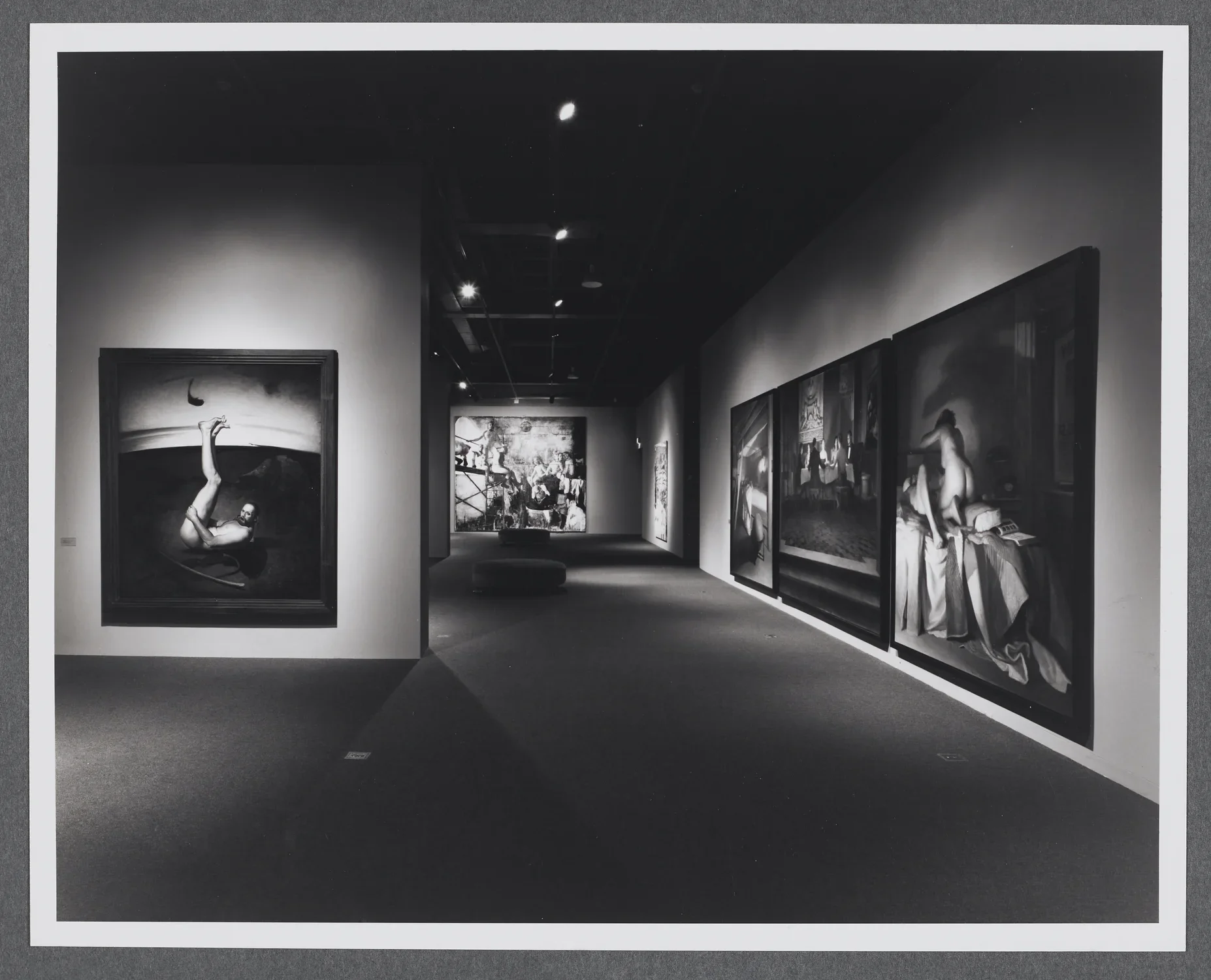 Large figurative paintings take up the gallery. Each painting has figures in a variety of poses and in different settings.