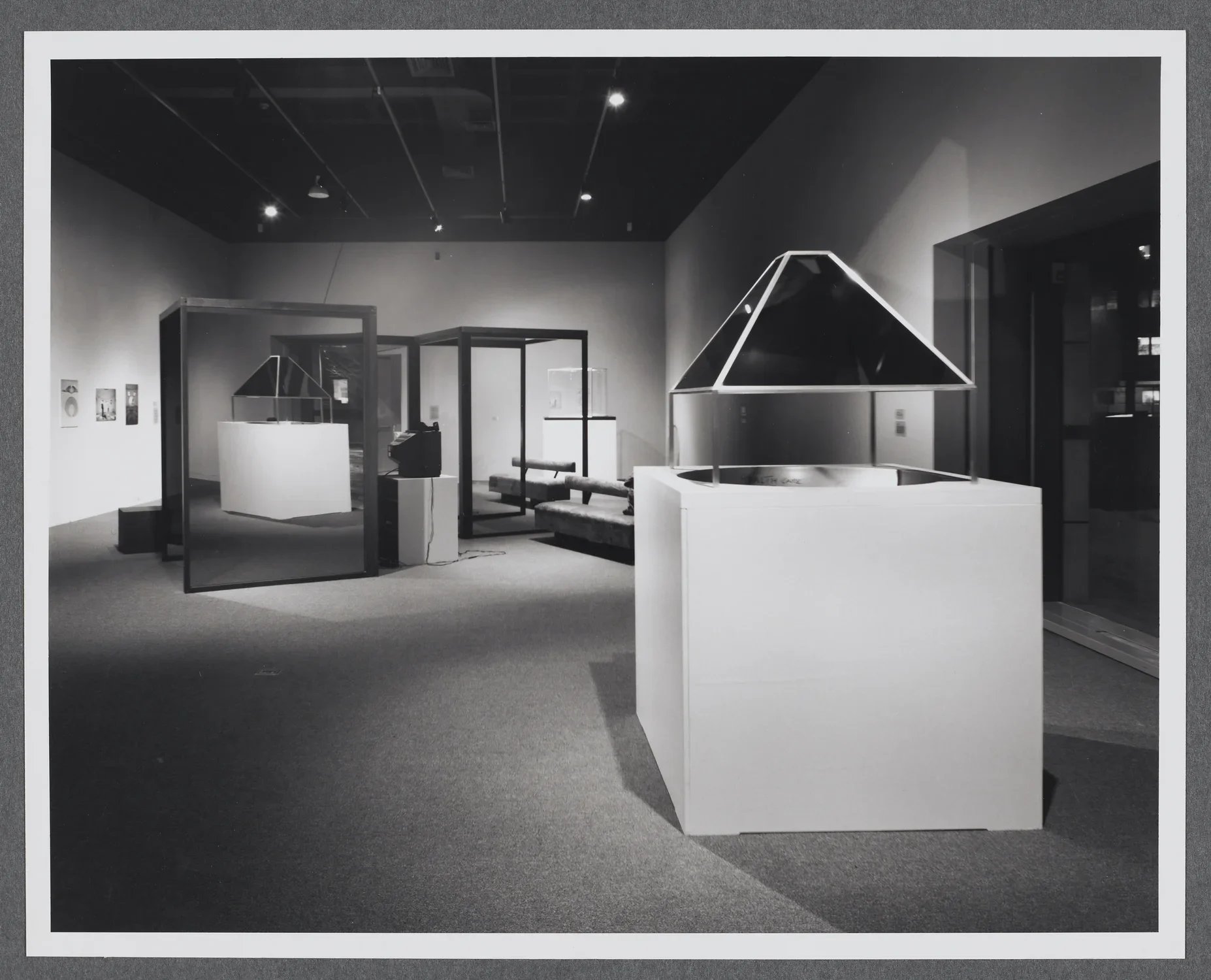 An installation using glass and mirror structures, video, and architectural models in the Hayden gallery of the List Center.
