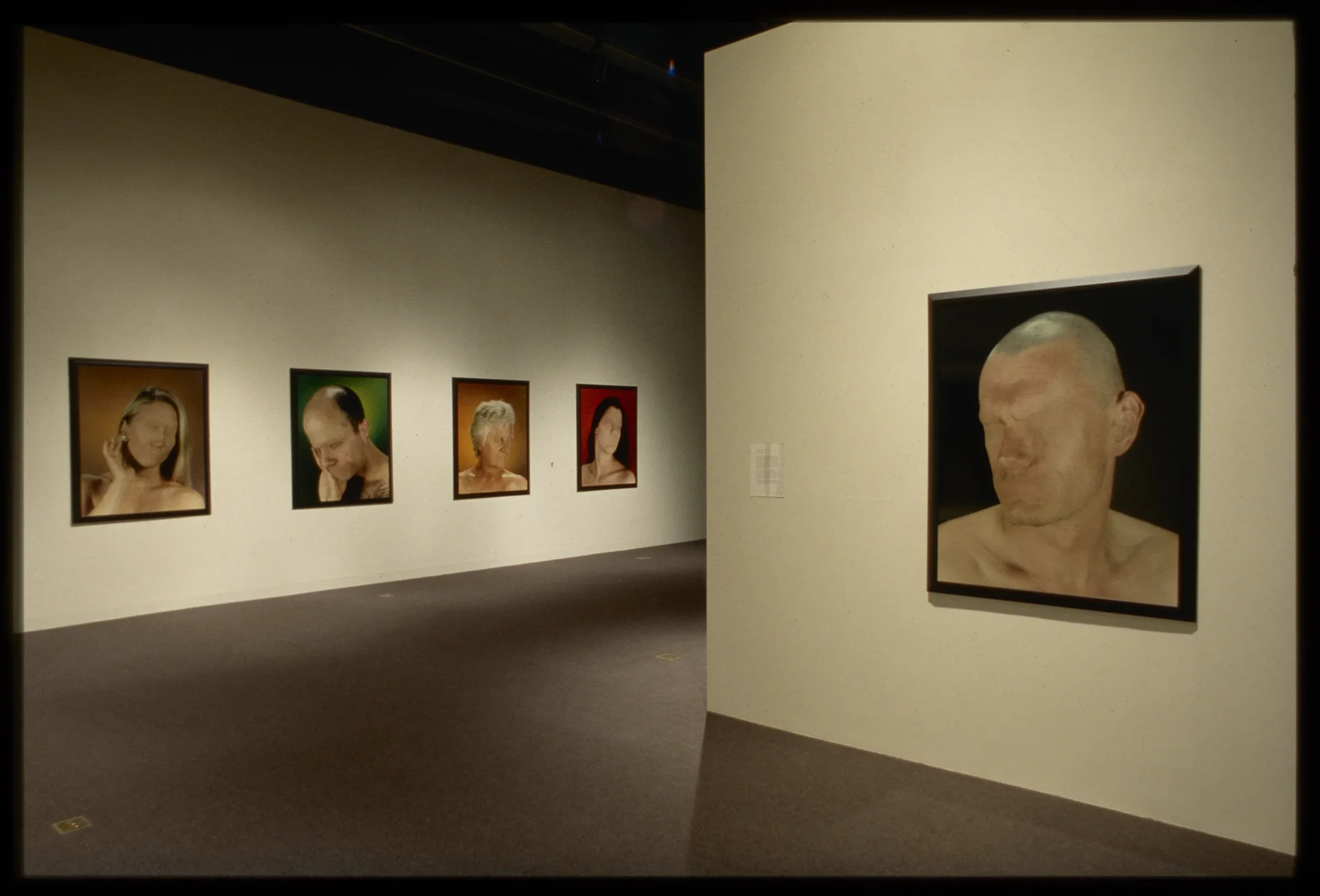 Five photos of nude headshots of people of various ages and genders with no eye or mouth, with different solid color backgrounds. 