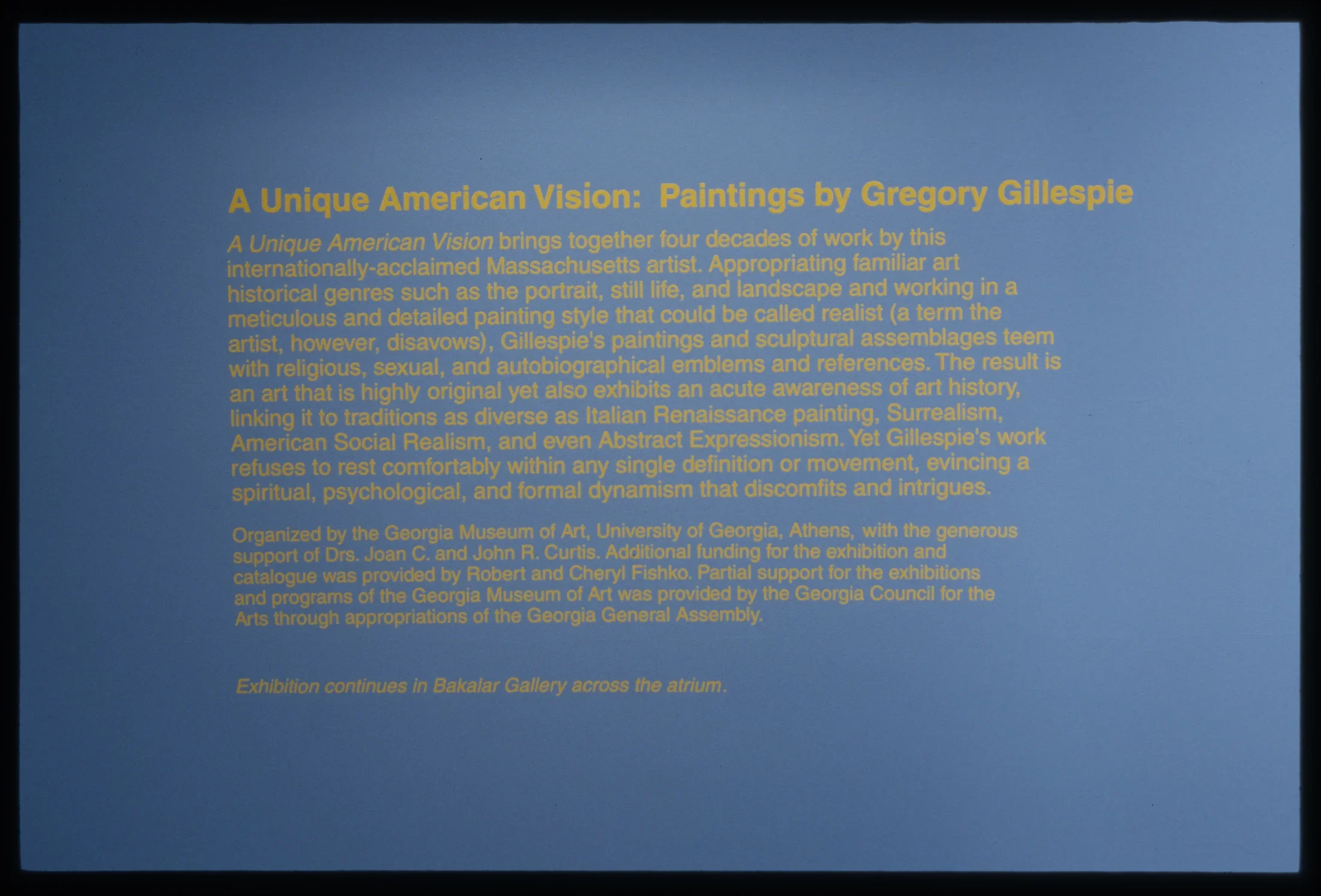 A blue wall with the welcome text to the space: A Unique American Vision.