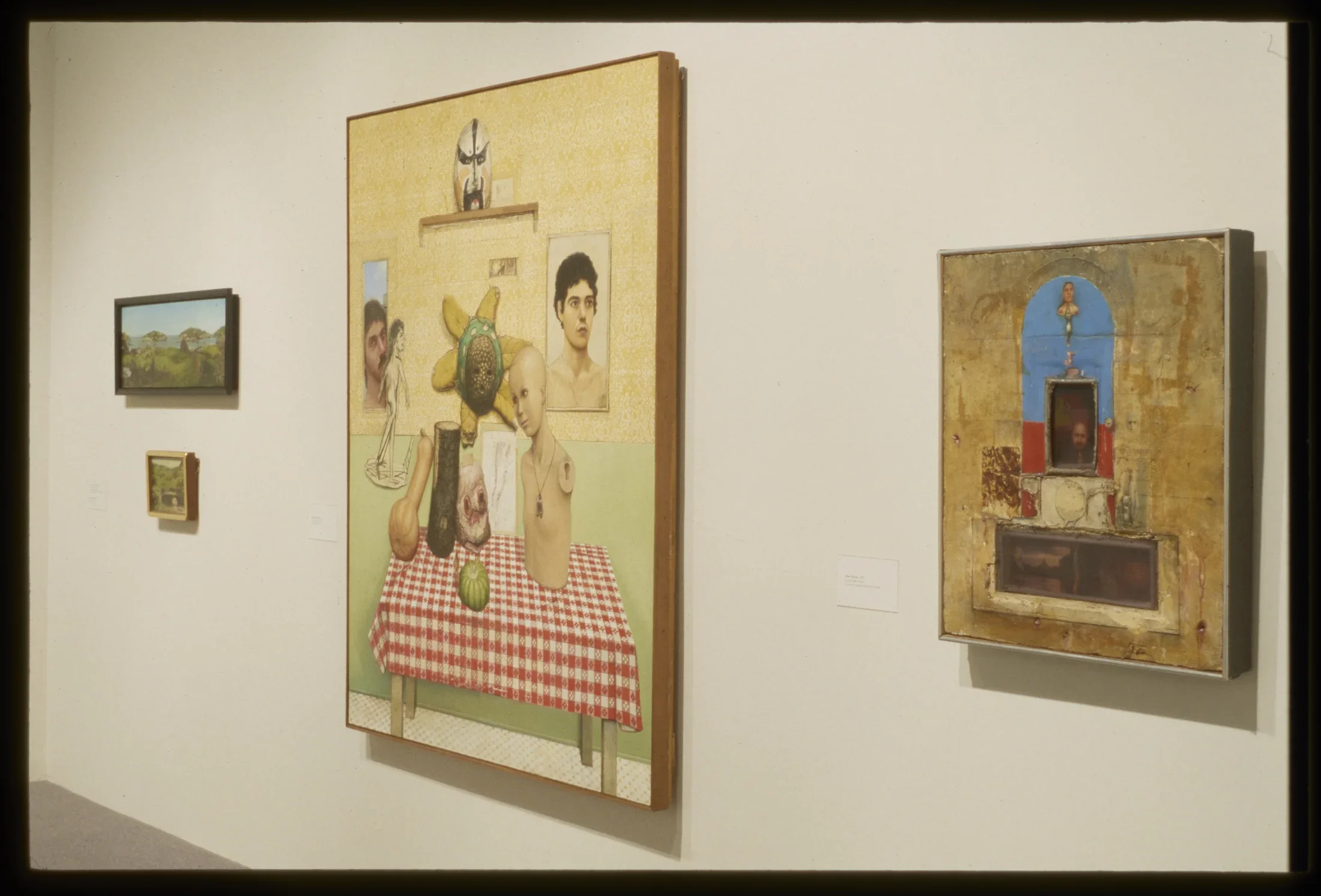 4 paintings on the wall of the gallery.