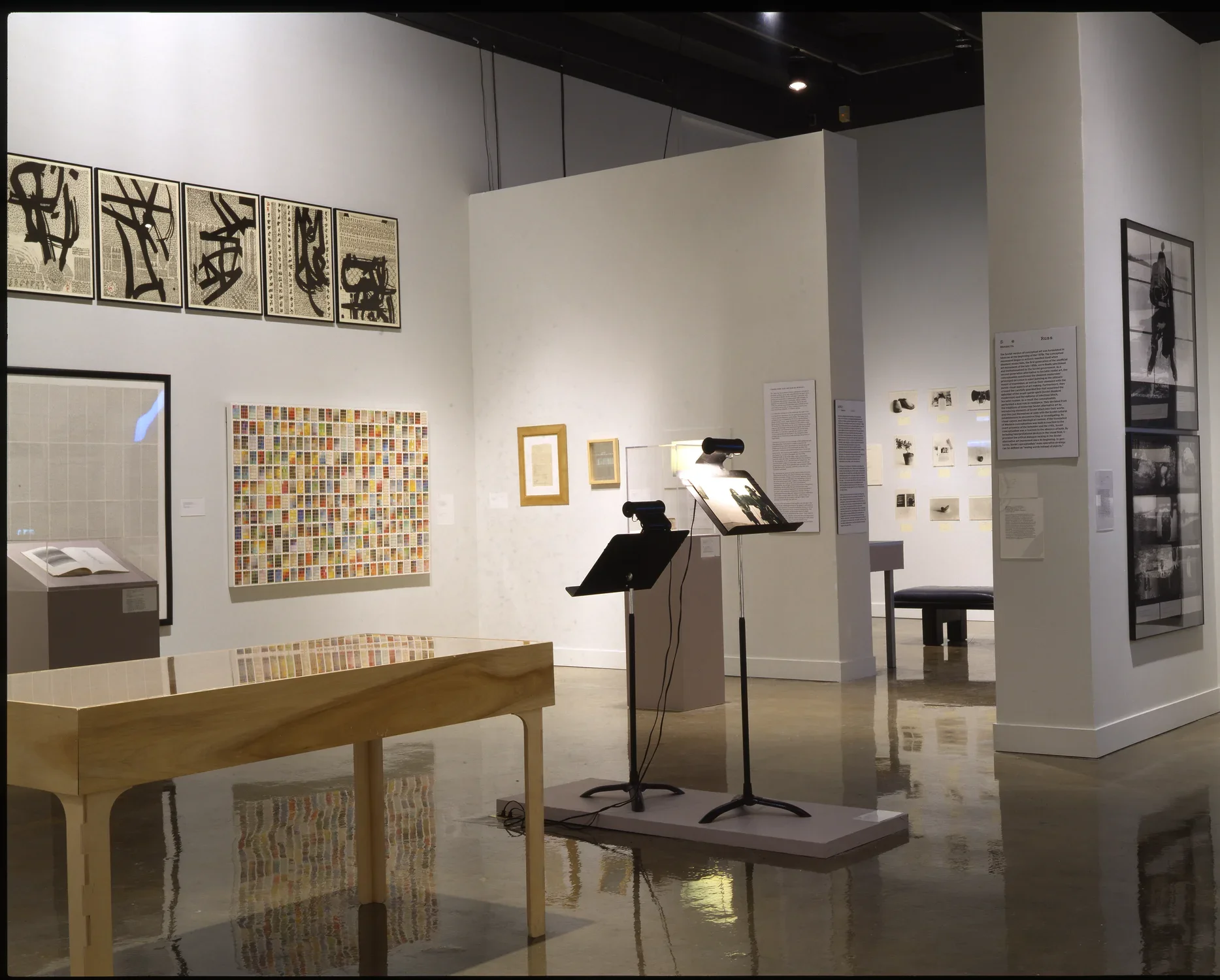 Artwork in various mediums and styles are spaced throughout the gallery on the walls, on stands, and in cases.