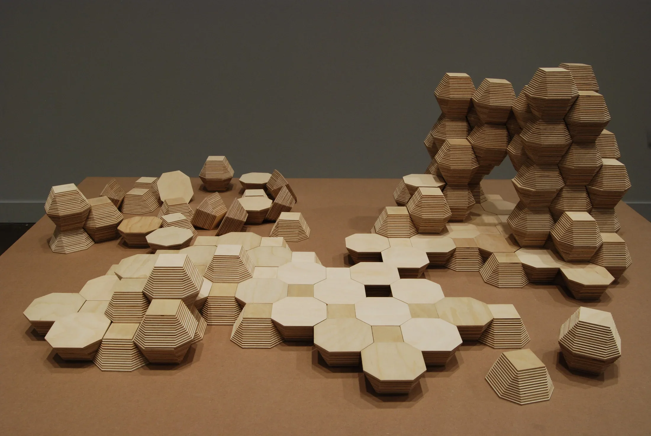Gray, white and black geometric drawing and rectangular intrusion create optical dimension within a white box.