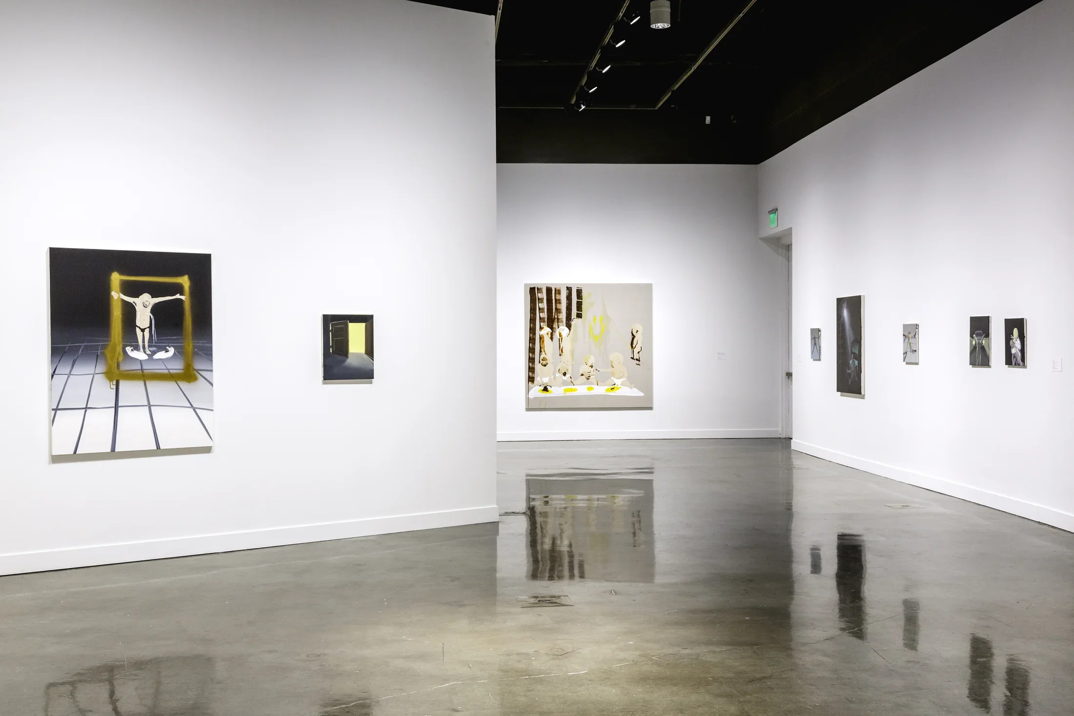 8 paintings of various sizes in muted tones installed on 3 white walls of the gallery