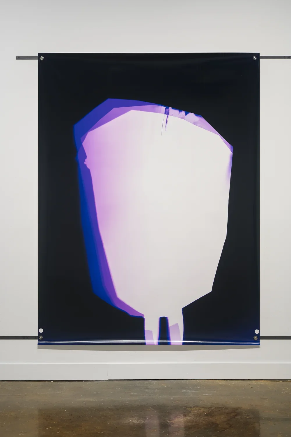 A large black, white, lavender print fastened to the wall with a thin metal rod across the top and another along the bottom