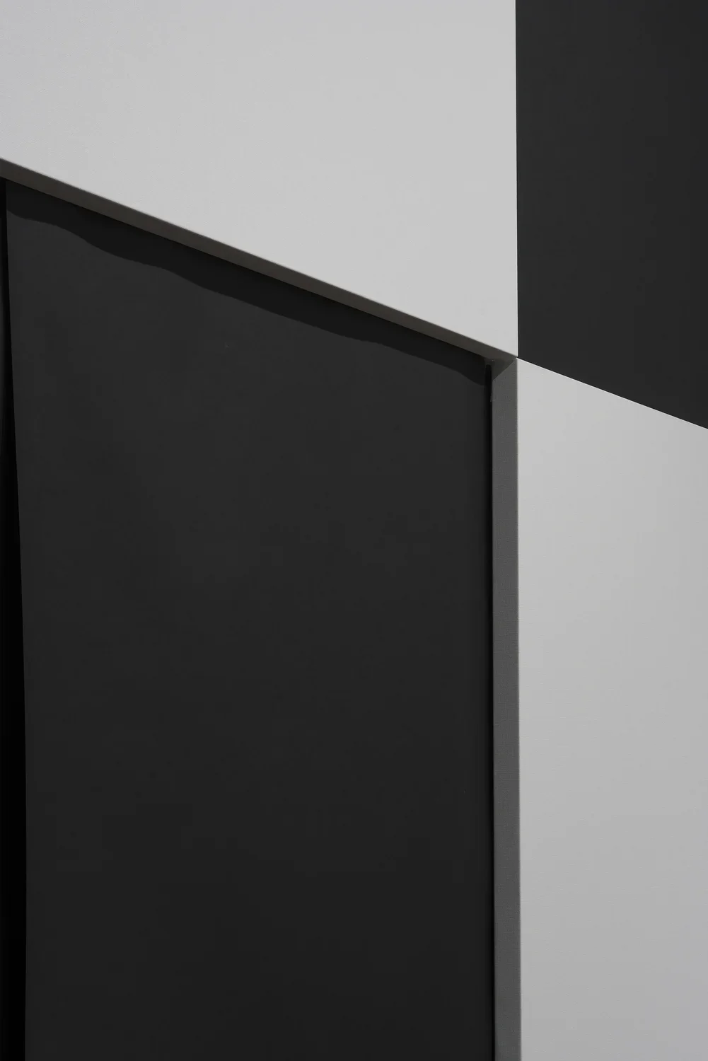 The intersection of 4 squares in a black and white checkerboard pattern. The white squares are raised panels.