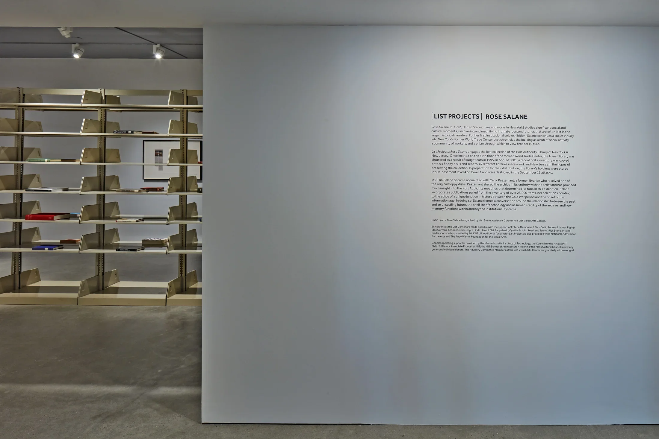 A gallery wall with vinyl letterrs reads "List Projects Rose Salane"