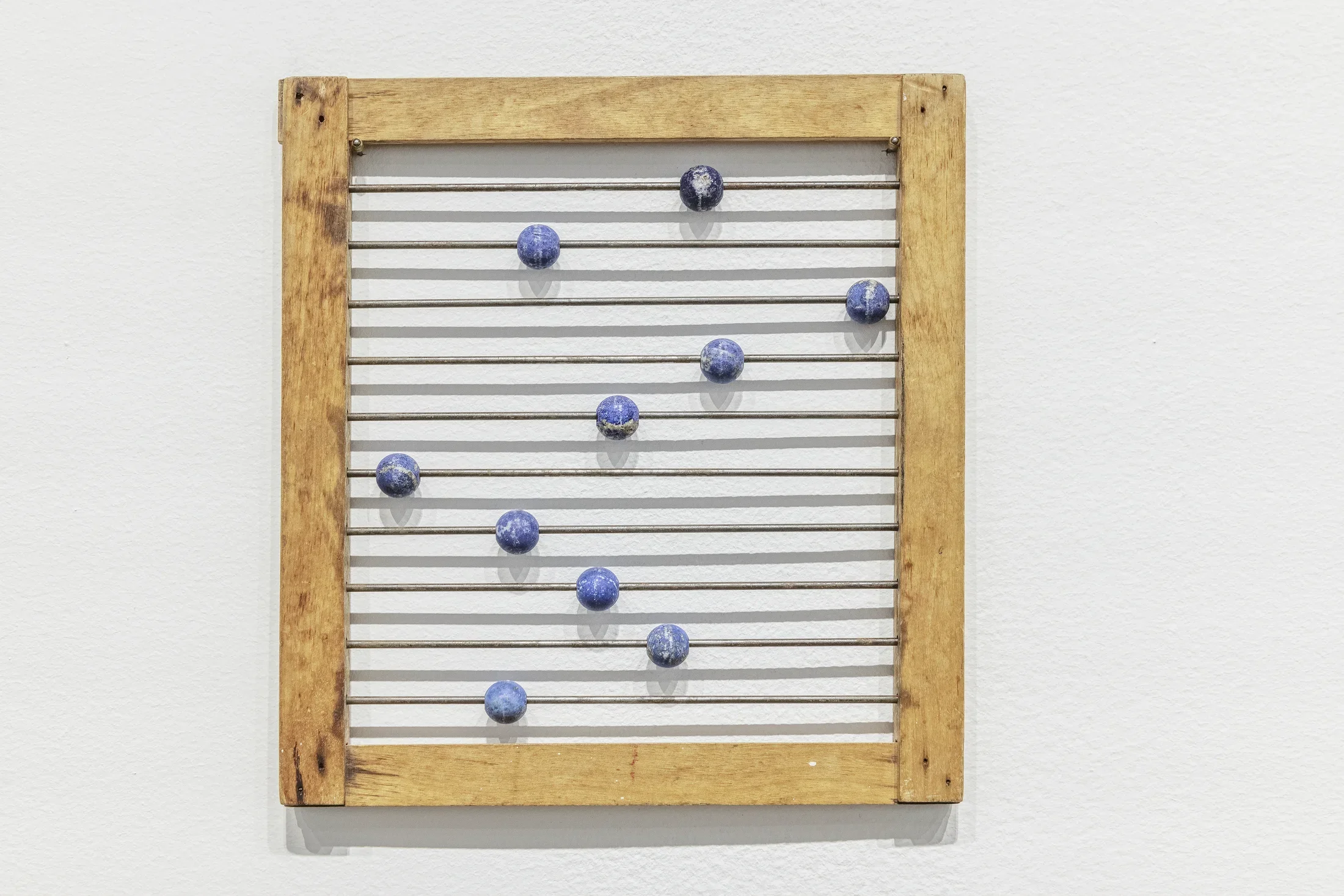 A small abacus with a wooden frame and lapis lazuli beads.