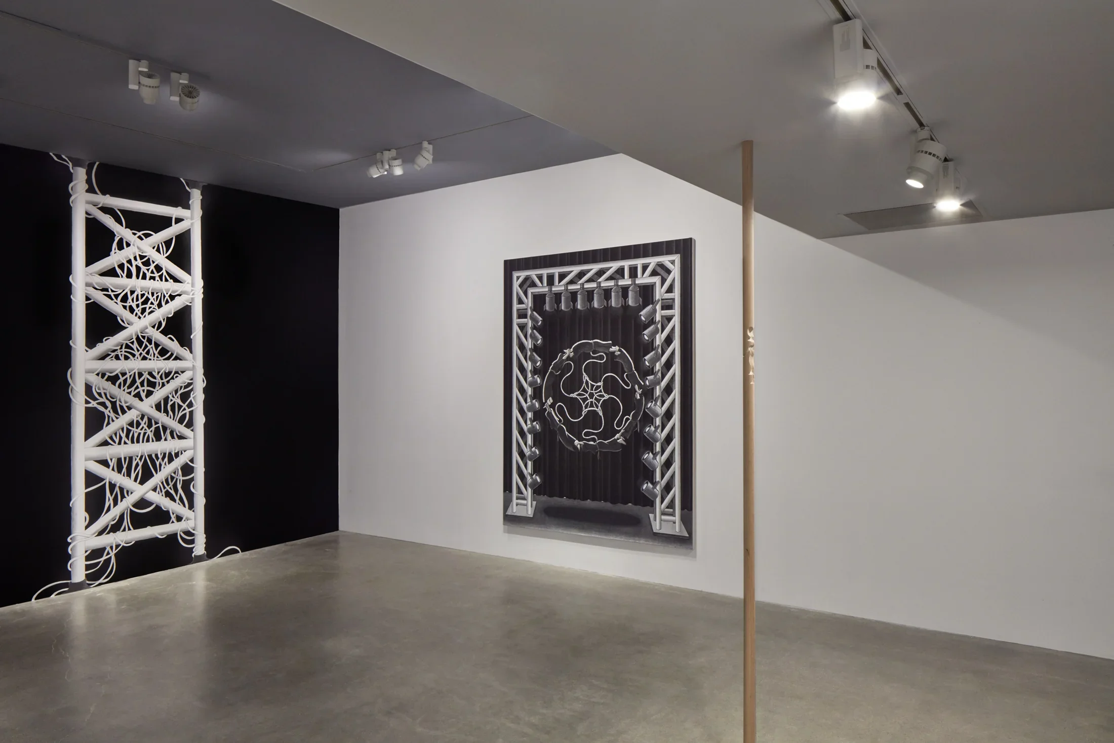 Installation view of project space gallery with pelvic bone painting hanging from the center, stagelight style painting in the background, and mural to the left.