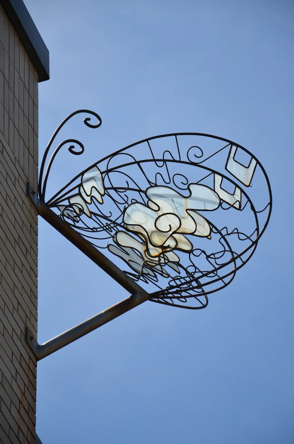 Wall-mounted  sculpture made of Wrought iron, soft steel, mirrored and colored plexiglas, marbles, and paint featuring 4 butterflies, each measuring several feet in diameter
