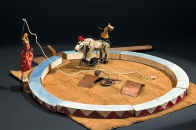 Close up of a miniature circus including a horse and ring.