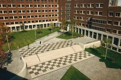 Courtyard with greenspace and brick buildings in the backyard.
