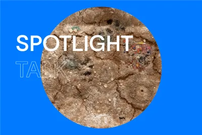 Blue background with white text that reads &quot;Spotlight Talk&quot; with a circular image in the center with dirt texture and some color.