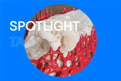 Blue background with white text that reads &quot;Spotlight Talk&quot; with a circular image of a red and white sculpture in the center.