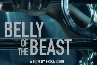 Movie poster that reads &quot;Belly of the Beast, a film by Erika Cohn&quot; in large white text over an image of a brown-skinned hand clutching a metal bedside rod with a handcuff clipped to the right of the hand on the same bedside.
