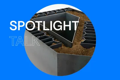 Bright blue background with white text that reads &quot;Spotlight Talk.&quot; In the center, there is a round image of a dark steel sculpture filled with dry, rocky soil. The structure has a hollow center, suggesting a courtyard of an architectural model.