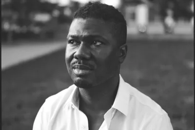 Black and white image of K. Anthony Jones wearing a white button down shirt