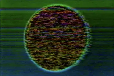 Video still of a dark black and red hued sphere in the center of the screen surrounded by green horizontal lines.