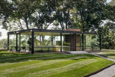 Philip Johnson's Glass House is pictured with surrounding greenery.