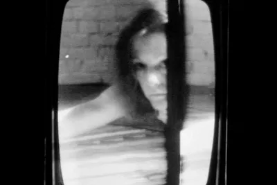 A black and whtie image of a woman's blurry face.