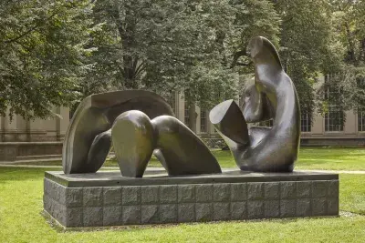 A Henry Moore Sculpture is photographed with surrounding greenery.