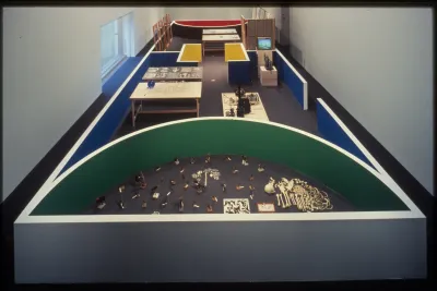 Short gallery walls create an architectural space within the gallery. Viewers can walk through and view a variety of objects. 