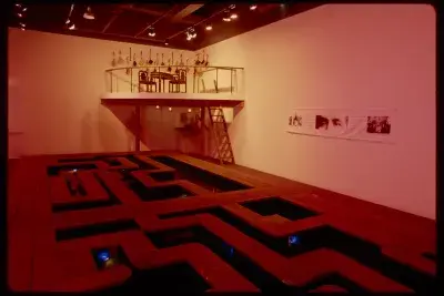 A walkway takes up the gallery while a rafter is set up the wall in the back corner. A ladder is set to climb the rafter. 