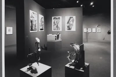 3D models sit on pedestals around the gallery. Large scale drawings hang on the gallery walls alongside the models. 