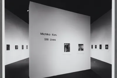 The title wall for Michiko Kon: Photographs sits at a diagonal in the center of the gallery space. Two photographs are displayed. 