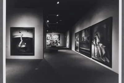 Large figurative paintings take up the gallery. Each painting has figures in a variety of poses and in different settings.