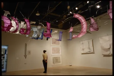 Large banners in red and white that appear to form the shape of a flying machine.
