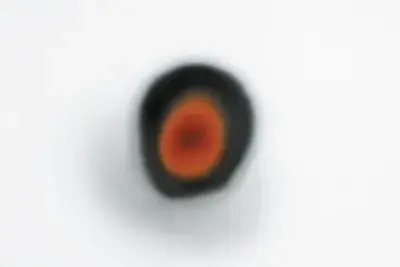 Blurred black spot with red interior, and a silver haze around the edges.