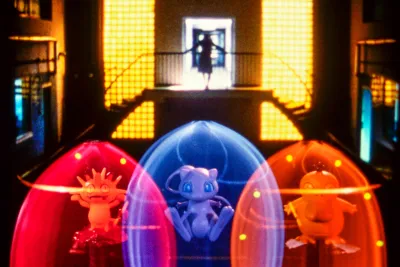 Three orbs of light feature Pokemon characters with a stage in the background.