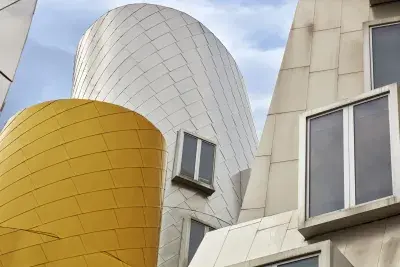 An extreme close up of a yellow and white structure on the MIT Stata Center.