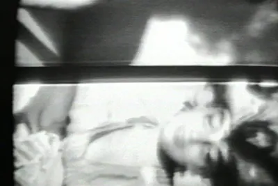 Black and white image of a woman lying on her side.