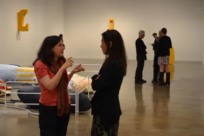 People stand in the List Center galleries in front of a soft sculpture.