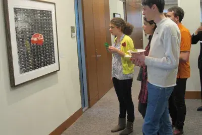 A group of students view an artwork.