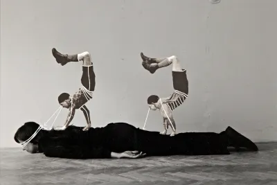 A collage with two acrobats on top of a person wearing black.