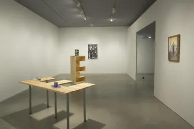 A gallery view of Lina Viste Grønli's exhibition at the List Center features an E-shaped shelf on an E-shaped table.