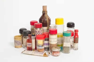 Various bottles and jars of spices labeled &quot;Rust Dust&quot; and &quot;Spice O Life&quot; by artist Ethan Hayes-Chute.