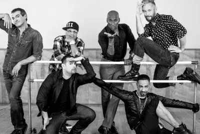 Black and white photo of Strike a Pose cast by ballet bars