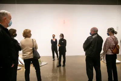 Paul Ha and Natalie Bell welcome guests inside of Sreshta Rit Premanth's exhibition, Grave Grove.