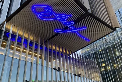 Large-scale animated LED sculptures that spell out a signature on the underside of a building overhang