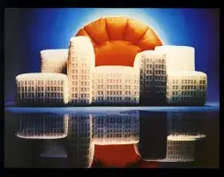 Book cover for Furniture by Architects featuring a building with the sun peaking out from behind that resembles a blow up house. The horizon is blue and the building and sun reflect on a black surface below.