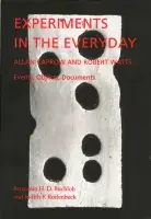 Black book cover for Experiments in the Everyday: Allan Kaprow and Robert Watts-Events,  Objects, Documents with red text and a wooden sculpture that has holes in it resembling a slice of Swiss cheese.