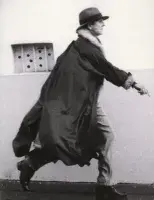 Book cover for Sturtevant: The Brutal Truth featuring a person walking on a sidewalk mid stride with their hand out in front of them wearing a baggy coat.