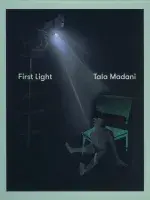 Book cover for First Light: Tala Madani featuring a man in the upper left corner sitting on a tall shelf shining a spotlight on a man who sites on the floor, wearing little closing in front of a large green folding chair.